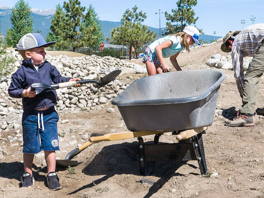 stone into wheelbarrow